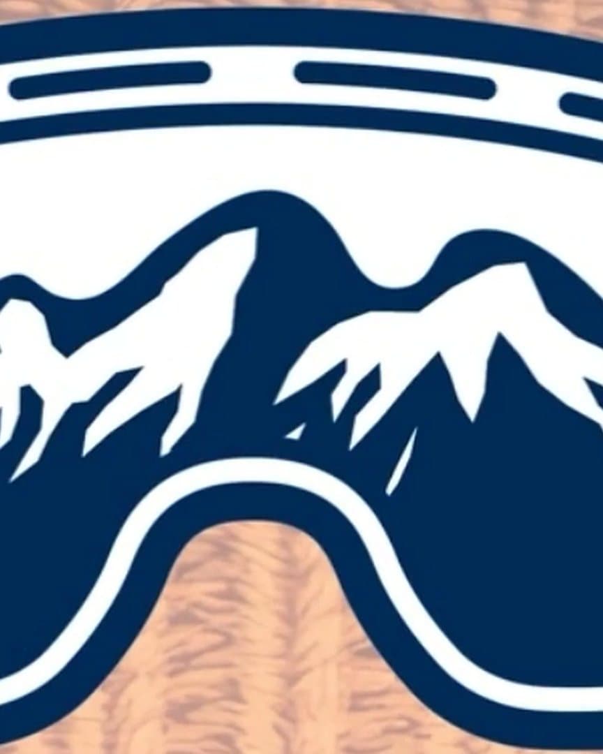 A ski goggle mark: navy mountains inside a white goggle frame, on a knitted ground