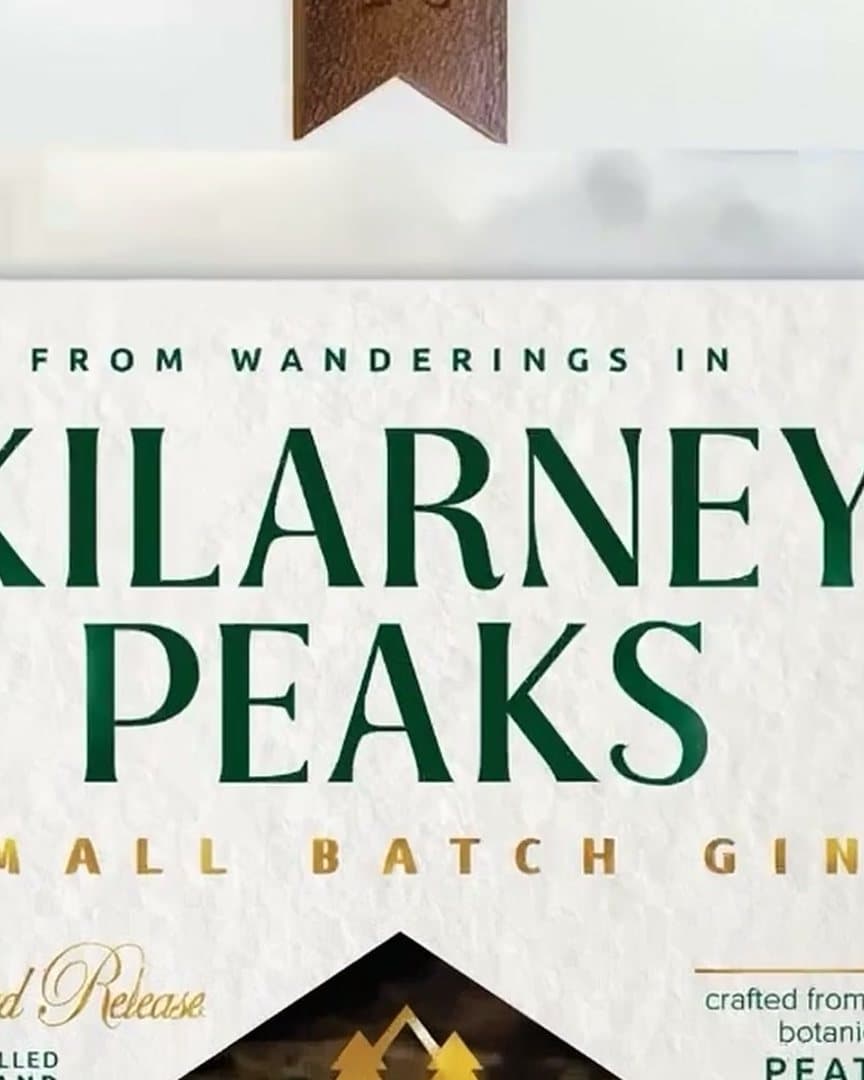 A gin label, Kilarney Peaks, small batch gin, in green and gold on cream